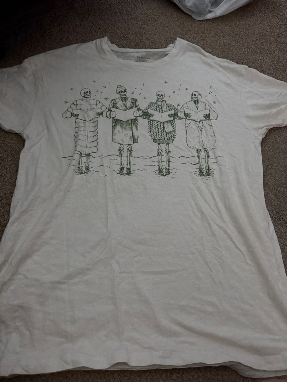 American Eagle Outfitters White Tee with Green Skeleton Carolers Graphic